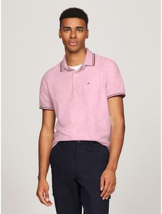 Tommy Hilfiger men's polo. A fresh spin on tradition, this regular fit polo is made from quick-dry, wicking fabric with ultraviolet protection and features our signature stripe tipping at the cuffs and collar. Comfort? Check. Performance? Style? Check.  Material: 60% Cotton. Classic Spring Polo Shirt For Golf, Sporty Polo Shirt With Striped Collar For Golf, Spring Sporty Polo Shirt With Ribbed Collar, Sporty Golf Polo Shirt With Striped Collar, Sporty Pink Collared Polo Shirt, Tommy Hilfiger Sporty Cotton Polo Shirt, Classic Polo Shirt With Striped Collar For Golf, Spring Polo Shirt With Contrast Stripes, Sporty Tommy Hilfiger Collared Polo Shirt