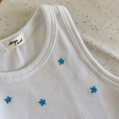 a white shirt with blue stars on it