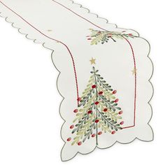 a white table runner with a christmas tree on the front and red berries on the back