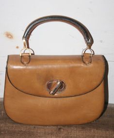 Loewe Tan / Brown Leather shoulder Handbag Vintage Purse Bag #3 One of several I'm listing this week In good used condition Missing pin where handle meets hardware on one side (has paperclip holding it there) A few wear marks, stains and what looks like glue from tape or something sticky (some loss of leather there as well) (as seen in photos) Zipper works well Shows signs of use and wear Measures appx 10.25" tall X 9" wide.... strap drop 4" Please use photos to aid in description ~ Please ask q Retro Brown Leather Shoulder Bag, Vintage Brown Soft Leather Bag, Retro Vintage Brown Shoulder Bag With Leather Handles, Retro Vintage Brown Top Handle Bag, Loewe Vintage Bag, Loewe Bag, Leather Shoulder Handbags, Vintage Purse, Woven Bag