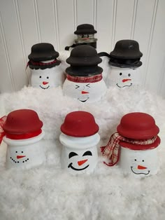 snowmen with hats and scarfs on top of white fluffy carpet next to each other