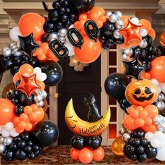 an arch decorated with balloons and halloween decorations