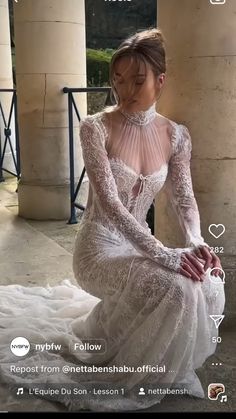 a woman in a wedding dress sitting on the ground with her hands behind her back