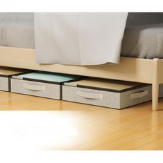 a bed with drawers underneath it on the floor