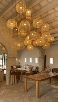 a living room filled with furniture and lots of lights hanging from it's ceiling