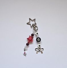 a key chain with charms attached to it on a white surface, including an eyeball and star