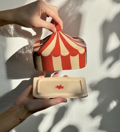 a person is pouring something out of a tin can into a container with a lid