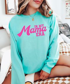 This cozy Comfort Colors sweatshirt is the perfect gift for a mama ( or for yourself of course)!  Featuring the saying "In my mama era" in bold letters on the front, this shirt is stylish and cute all year wear. For the tshirt: https://www.etsy.com/listing/1548009857/in-my-mama-era-shirt-trendy-mama-tshirt?click_key=0f581a37d9e6a6918175be8fd06b9489a96a6bb7%3A1548009857&click_sum=f6026103&ref=shop_home_active_1&pro=1&sts=1 𝐇𝐎𝐖 𝐓𝐎 𝐎𝐑𝐃𝐄𝐑 1. Select the size & color when/if applicable 2. Ad Crew Neck Top For Loungewear, Crew Neck Top For Mother's Day Loungewear, Crew Neck Top For Loungewear On Mother's Day, Mother's Day Cotton Sweatshirt With Slogan, Relaxed Fit Sweatshirt For Mother's Day Loungewear, Mother's Day Relaxed Fit Sweatshirt For Loungewear, Cute Green Sweatshirt With Letter Print, Mother's Day Crew Neck Sweatshirt With Lettering, Mother's Day Lettering Crew Neck Sweatshirt