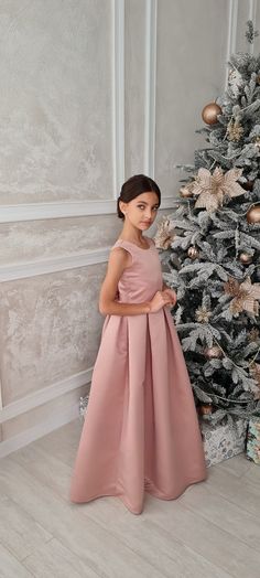 Introducing the enchanting Brookelle Satin Tulle Pageant Dress for Girls from Blush Kids - a masterpiece that embodies elegance and grace in every stitch. Crafted from premium quality satin, this exquisite dress features a chic tank top style bodice that gently caresses your princess's form, leading to an alluring plunging deep V backline that adds a dash of sophistication and charm. At the waist, a tastefully placed bow accentuates the silhouette, providing an impeccable fusion of style and swe Chic Tank Tops, Girls Communion Dresses, Girls Crown, Flower Girl Crown, Christening Outfit, Satin Tulle, Girls Pageant Dresses, Christening Dress, Communion Dresses