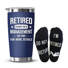 two pairs of socks next to a travel mug with the words, i'm not retired under new management see wife for more details