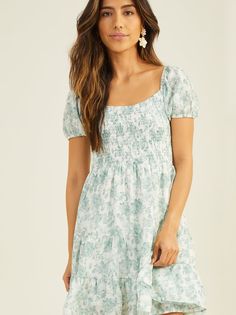 Dance into warmer weather with this floral mini dress. Puff sleeves add a touch of playful romance, while the smocked top provides comfort, ensuring you twirl with effortless confidence. Feminine Flowy Floral Dress With Puff Sleeves, Fitted Floral Dress With Smocked Back And Puff Sleeves, Puff Sleeve Floral Dress With Smocked Bodice For Brunch, Mini Dress With Smocked Bodice For Garden Party, Garden Party Mini Dress With Smocked Bodice, Garden Party Mini Dress With Gathered Sleeves, Spring Brunch Puff Sleeve Dress With Ditsy Floral Print, Fitted Floral Mini Dress With Smocked Back, Flirty Puff Sleeve Mini Dress With Floral Print