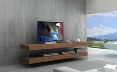 a living room with a large television on top of a wooden shelf