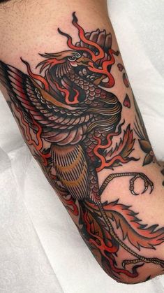 a man's leg with a tattoo on it and a bird in the middle