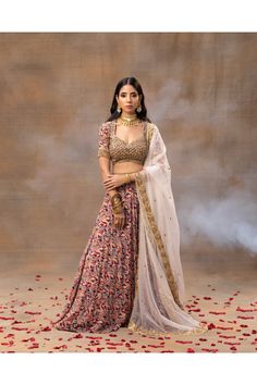 A perfect blend of elegance and finesse. This ensemble features intricate gold embroidery and fine detailing, exuding opulence and charm. The heavy embroidery adds a touch of regality, making it an ideal choice for lighter bridal occasions. The choli's elbow-length sleeves provide comfort and sophistication, making this outfit a must-have for every fashion-forward bride-to-be. Color : IVORY Fabric : CREPE/ORGANZA Components : 3 Wash Care : DRY CLEAN ONLY Delivery Time : 10 days Elegant Lehenga With Floral Embroidery In Traditional Drape, Elegant Lehenga With Floral Embroidery, Elegant Embroidered Choli With Traditional Drape, Elegant Sharara With Gold Embroidery In Traditional Drape, Elegant Silk Anarkali Set With Gold Embroidery, Elegant Chanderi Choli For Transitional Season, Elegant Sharara With Gold Embroidery And Traditional Drape, Elegant Sharara With Gold Embroidery For Festive Occasions, Elegant Silk Lehenga With Floral Embroidery