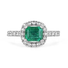 Behold a mesmerizing emerald and diamond engagement ring that captures the essence of timeless elegance. Featuring a magnificent 1.70-carat emerald cut emerald, the vibrant gemstone takes center stage as it is set horizontally, east to west, within secure prongs. The emerald dazzles with a lush and rich green color, boasting beautiful characteristics that reflect its natural allure. Surrounding the emerald, a brilliant round cut diamond halo, intricately pave-set, adds a captivating brilliance and enhances the emerald's beauty. The diamond-adorned shank gracefully extends halfway down, perfectly crafted in lustrous 14k white gold, completing this exquisite symbol of everlasting love. Setting Style: Prong/Pave Setting Material: 14K White Gold Setting Weight: 3.5 Grams Main Stone: Emerald Sh Emerald Ring With Center Stone In 14k White Gold, Dazzling Emerald Diamond Ring With Brilliant Cut, Fine Jewelry Emerald Ring With Platinum, Classic Green Cluster Ring With Brilliant Cut, Dazzling Platinum Emerald Ring With Center Stone, Dazzling Platinum Emerald Ring, Green Brilliant Cut Platinum Halo Ring, Fine Jewelry Emerald Ring With Princess Cut, May Birthstone Emerald Ring With Brilliant Cut In Platinum