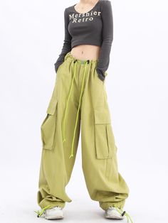 Elevate your casual look with our Oversized Baggy Cargo Pants. Featuring a trendy Y2K influence, these streetwear essentials by Acubi offer a relaxed fit, drawstring waist, and functional pockets for a fashionable and comfortable outfit. Spring Utility Cargo Pants Full Length, Spring Utility Full Length Parachute Pants, Khaki Utility Cargo Jeans With Elastic Waistband, Full Length Cargo Pants For Spring, Full-length Spring Cargo Pants, Spring Full Length Cargo Pants, Trendy Relaxed Fit Tapered Leg Cargo Pants, Baggy Casual Cargo Pants With Pockets, Baggy Cargo Pants With Cargo Pockets