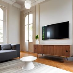 a large flat screen tv mounted to the side of a wall in a living room