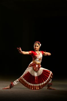 a woman in a red and white dress dancing