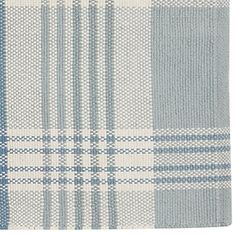 a blue and white plaid rug on a white background