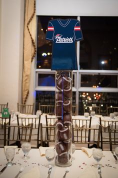 a tall vase filled with chocolate covered doughnuts on top of a white table