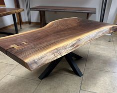 a wooden bench sitting on top of a tiled floor