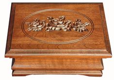 a wooden box with flowers carved on it