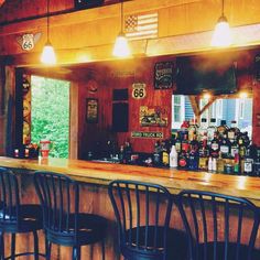 a bar with several stools in front of it