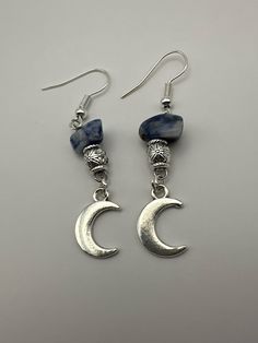 Silver crescent moon earrings with blue rocks and a silver bead. Blue Round Earrings With Moon Charm, Blue Crescent Moon Charm Earrings, Blue Moon Shaped Earrings With Moon Charm, Blue Moon-shaped Sterling Silver Earrings, Blue Moon-shaped Earrings With Moon Charm, Moon Rock, Crescent Moon Earrings, Blues Rock, Moon Earrings