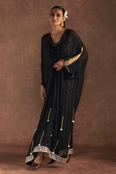 Black kaftan with paan-patti motif embroidered on sleeve, gota and tassel accents with gathered waist. Comes with an all-over irisbud foil printed slip. - Aza Fashions Traditional Kaftan With Tassels, Elegant Long Sleeve Kaftan With Tassels, Bollywood Style Festive Kaftan With Tassels, Designer Black Kaftan With Resham Embroidery, Traditional Long Sleeve Kaftan With Tassels, Evening Kaftan With Tassels, Festive Traditional Kaftan With Tassels, Traditional Tassel Kaftan With Drape, Traditional Tasseled Kaftan