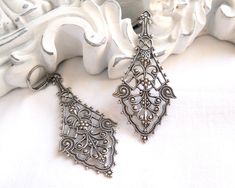 Lovely long victorian style sterling silverplated brass filigree pendant earrings. The lever back earwire is made of sterling silverplated brass. brass. The length of the earrings including the earwire is ± 7 cm. (2.7 inches) For other jewelry please visit our shop: http://www.minouc.etsy.com For combined shipping please contact us. We also combine shipping with our other Etsy shop where we sell vintage fabrics and finds from Holland and France: http://www.minoucbrocante.etsy.com Victorian Chandelier Earrings With Intricate Design, Victorian Chandelier Dangle Earrings With Intricate Design, Ornate Filigree Chandelier Earrings For Formal Occasions, Victorian Filigree Chandelier Dangle Earrings, Antique Filigree Chandelier Drop Earrings, Victorian Chandelier Drop Earrings With Intricate Design, Antique Chandelier Earrings With Intricate Design, Victorian Filigree Drop Earrings, Victorian Style Filigree Drop Earrings