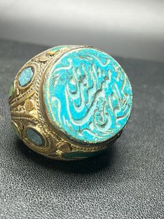 This vintage Islamic stamp seal, set in a copper ring, showcases intricate intaglio carvings with timeless elegance. Dating back to the ancient period, the detailed design reflects the rich artistry and cultural heritage of Islamic craftsmanship. A distinctive piece that combines historical significance with classic style. Vintage Ceremonial Engraved Ring With Intricate Design, Antique Carved Signet Ring, Traditional Carved Ceremonial Rings, Antique Ceremonial Ring With Intricate Design, Ceremonial Antique Rings With Antique Finish, Traditional Carved Rings For Ceremonial Occasions, Antique Engraved Ring With Intricate Design For Ceremonial Use, Antique Engraved Ring For Ceremonial Occasions, Antique Round Signet Ring With Intricate Design