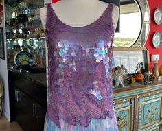 70s Vintage Purple Lavender Iridescent Sequin and Beaded Top. Incredibly gorgeous Lavendey purple color.  Sequins and Beading completely hand stitched! I love this top, and am a bit reticent to give it up, but I don't wear it, and want someone else who will and who love it to grab it! No matter if you wear as shown with a vintage Betsey Johnson skirt, with a pair of shorts, a pair of torn up jeans, or pair of dress pants, you will shimmer aplenty. A great find and addition to any wardrobe. You might just want to hang it up in your room and look at it cause it makes you happy! PS. Pretty sure it is Oleg Cassini as I have a similar top in Turquoise with his label.  Please check measurements to assure a proper fit.  Measurements taken flat!  Please double for full circumference Label: N/A but Festive Purple Sequin Blouse Piece, Vintage Purple Top, Purple Mermaid Top Aesthetic, Fitted Purple Sequin Top, Vintage Sleeveless Sequin Top, Iridescent Sequin, Beaded Skirt, Vintage Betsey Johnson, Skirt Purple