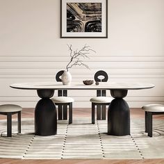 a dining room table with four chairs and a vase on the top, in front of a white wall