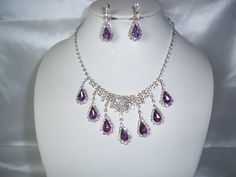 Pretty purple necklace and earrings set. Perfect for bridesmaid, mother of the bride, party, Quenceanera, pageant or any special occasion. Returns & exchanges I gladly accept cancellations Request a cancellation within: 1 hours of purchase I don't accept returns or exchanges But please contact me if you have any problems with your order. We are NOT responsible for any Rhinestones that come lose after it was shipped. Refunds are for the amount of the item(s) purchased only. Shipping costs are not Wedding Costume Jewelry Teardrop, Dangle Jewelry With Bling For Wedding, Wedding Dangle Jewelry With Bling, Dangle Bling Jewelry For Wedding, Elegant Purple Crystal Rhinestone Necklace, Elegant Purple Rhinestone Crystal Necklace, Purple Sparkling Stones Necklace For Wedding, Purple Rhinestone Necklace For Wedding, Purple Sparkling Stone Necklaces For Wedding