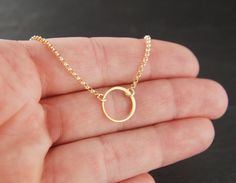 Small gold circle link and gold filled necklace, tiny circle necklace, infinity necklace, simple gold necklace, gold ring A 24 karat over sterling silver round link (12mm) is suspended from a 14 karat gold filled chain that can be up to 22 inches in length. The chain is secured with a 14 karat gold filled clasp. The circle is made of round wire and the other part is flattened wire. Your purchase will arrive in a jewelry box ready for gift giving or as a gift for yourself! Enter my shop here: jer Dainty Tiny Recycled Gold Jewelry, Tiny Gold-plated Minimalist Jewelry, Tiny Minimalist Gold Plated Jewelry, Delicate Tiny Gold Jewelry, Minimalist Circle Charm Gold Necklace, Gold Circle Minimalist Charm Necklace, Minimalist Gold Circle Charm Necklace, Dainty Recycled Gold Jewelry With Simple Design, Delicate Circle Chain In Yellow Gold