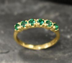 Half Eternity Ring set with a Create Emerald in a flawless diamond cut, clarity & color, 3mm each (1 Carat all), Band width 2mm. Gold Eternity Ring design - Gold Vermeil: 18k Gold Plating on Solid 925 Sterling Silver. Click here for ☞ Matching Pendant ☞ Choose your size ☞ I resize (before shipping) for FREE to Any size* Details : ♥ Each item comes in a cute GIFT BOX ✓ ♥ GUARANTEE on the materials ✓ ♥ Created Emerald - diamond cut, flawless clarity & deep green color ✓ ♥ Pure Solid 925 Sterling Silver ☞ Silver Hallmark on each piece ♕ ♥ The ring is plated with 14K Gold (the thickest plating - 3 Micron) ✓ ♥ Measurements: Emerald size 3 millimetres diameter, 1 Carats all ✓ ♥ Band Width 2mm, Thickness 0.9mm ✓ ♥ Each stone is set professionally - Real Jewelry artisan work ♕ ♥ More Beautiful jew Green Diamond Rings, Gold Emerald Ring, Gold Eternity Ring, Eternity Ring Set, May Birthstone Rings, Eternity Ring Gold, Flawless Diamond, Emerald Ring Gold, All Band