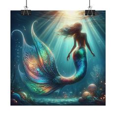 a mermaid with long hair is sitting in the water and looking up at the sky