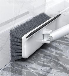 a brush is sitting on top of a tile floor