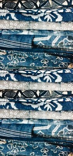 several pieces of blue and white fabric with designs on the side, all in different sizes