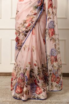 Blush pink saree featuring floral print with contrast blue piping on the hem. Comes with an unstitched blouse piece. - Aza Fashions Pink Pre-draped Saree With Printed Border For Wedding, Pink Anarkali Style Silk Pre-draped Saree, Pink Silk Bollywood Pre-draped Saree, Transitional Pink Chanderi Pre-draped Saree, Pink Sheer Dupatta Blouse Piece For Diwali, Pink Saree With Sheer Dupatta For Eid, Pink Bollywood Silk Pre-draped Saree, Pink Bollywood Style Pre-draped Silk Saree, Pink Blouse Piece With Sheer Dupatta