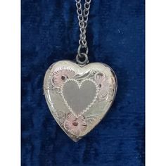 Vintage Sterling Silver 18" chain & about 1" heart locket. Front of heart has decorative etching with slight pink and yellow tones. Silver is tarnished on heart and chain. Comes in original box which shows some wear. Appears to not have been worn. Collectible Heart-shaped Hallmarked Jewelry, Vintage Personalized Double Heart Necklace, Vintage Nickel-free Heart Necklace For Anniversary, Silver Vintage Heart Necklace With Charm, Vintage Metal Heart Locket Necklace, Vintage Metal Heart Necklace For Valentine's Day, Vintage Open Heart Necklace For Keepsake, Vintage Engraved Double Heart Necklace, Vintage Open Heart Keepsake Necklace