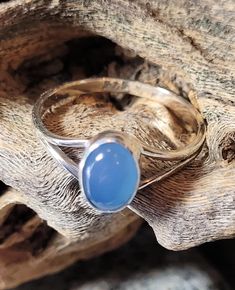 These are sterling silver and blue chalcedony rings. Blue chalcedony is a type of quartz that looks like a bluebird sky. The stone is 7 by 5 mm or just over 1/4 of an inch tall. These are new, unworn, old store stock. They retailed at $52 and come in a gift/jewelry box. Spiritual Blue Moonstone Ring, Adjustable Blue Moonstone Cabochon Ring, Adjustable Blue Cabochon Moonstone Ring, Adjustable Blue Moonstone Ring With Cabochon, Blue Moonstone Healing Ring, Classic Oval Blue Moonstone Ring, Adjustable Blue Moonstone Ring, Oval Blue Opal Ring Hallmarked, Classic Blue Moonstone Ring For Anniversary