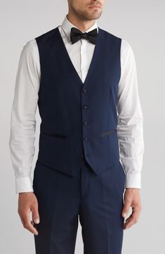 Bring understated elegance to the table in this three-piece tuxedo crafted from rich fabric in a classic single-breasted silhouette. Jacket has shawl collar; chest welt pocket; front welt pockets Vest has front button closure; V-neck Pants have zip fly with button closure; front slant pockets; back button-welt pockets Jacket and vest are lined; trousers are lined to the knee 65% polyester, 35% viscose Dry clean Imported Each suit has a 6” drop, meaning that a size 38R jacket is paired with size Fitted Semi-formal Set With Suit Collar, Formal Tuxedo Sets With Slim Fit, Elegant Black Tie Slim Fit Three-piece Suit, Fitted Tuxedo Sets For Formal Occasions, Classic Fitted Formal Sets, Classic Fitted Sets For Formal Occasions, Classic Fitted Sets For Semi-formal Occasions, Elegant Fitted Semi-formal Sets, Classic Fitted Three-piece Suit For Black Tie Event