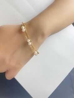 Our stunning bracelet is made of natural pearls connected with 14k gold filled cable chain, layered with 14k gold filled bead chain. The double layer design make this bracelet minimalist but elegant and surely eye-catching! Freshwater pearl size is 5mm Bracelet length is 18+4.5 As it's a handmade item please allow 2-3mm difference. Please let me know if you would like a different chain or length. Please keep them away from chemicals such as perfume, hairspray ect. Better remove before shower and swim.   The product is made by care and love 💕 Delicate Gold Chain Bracelet With Pearls, Gold Pearl Bracelet With 14k Gold Filled Pearl Chain, Gold 14k Gold Filled Pearl Chain Bracelet, Dainty Gold Pearl Chain Bracelet, Gold Pearl Chain Bracelet In 14k Gold Filled, Dainty Gold-plated Pearl Bracelet With Adjustable Chain, Dainty Gold Plated Pearl Bracelet With Adjustable Chain, Dainty Gold Plated Pearl Chain Bracelet, Dainty Rose Gold Pearl Chain Bracelet