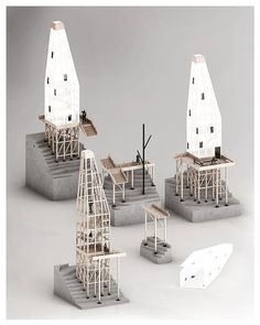 three models of buildings made out of wood and concrete