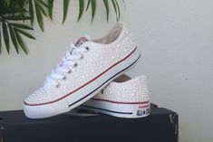 "The Converse is one size larger. Make sure you order the right size. These are custom made and non-refundable. More converse. https://www.etsy.com/shop/ZorzosCollection?ref=seller-platform-mcnav We can work with you to create the perfect dream couple of personalized wedding instructors. Choose your Converse color, your crystals, your ink color and leave the rest to us. Each order includes extra stones and original laces. If you would prefer the all white converse, please feel free to contact us Converse White Platforms With Gold Accents, Wedding Converse Clogs & Mules, Pearl Converse, All White Converse, Star Logos, Dream Couple, Bling Converse, Custom Converse, Pearl Accessories