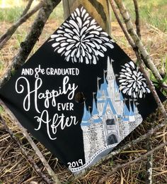 a black graduation cap with the words happily ever after written in front of a castle