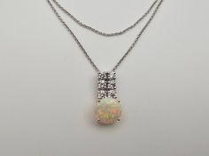 Vintage 14kt White Gold Diamond and Opal Necklace Item w#1810 Clean and in good condition  Marked 14k .60 Carat Total Round Cut Natural Diamonds Color G-H Clarity SI2-I1 1.09 Carat Oval Natural Opal 5 gram 19 Inch chain with a spring ring clasp Pendant is approx. 20mm x 10.6mm Welcome to Westgate Jewels! At Westgate Jewels, we specialize in vintage estate jewelry, vintage designer jewelry, Vintage Native American jewelry and wears, Collectables, and Vintage fine karat gold and sterling silver je Fine Jewelry White Necklace With Round Stone, White Round Stone Necklace In Fine Jewelry Style, White Fine Jewelry Necklaces With Round Stone, White Diamond-cut Round Stone Jewelry, White Jewelry With Diamond Cut Round Stone, White Diamond Cut Round Stone Jewelry, White Diamond Multi-stone Jewelry, White Round Stone Diamond Cut Jewelry, White Necklace With Diamond Accents And Round Stone