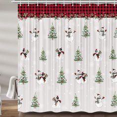 a christmas themed shower curtain with snowmen and trees