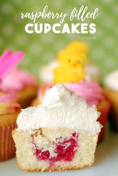 raspberry filled cupcakes on a plate with the rest of the cupcake in the background